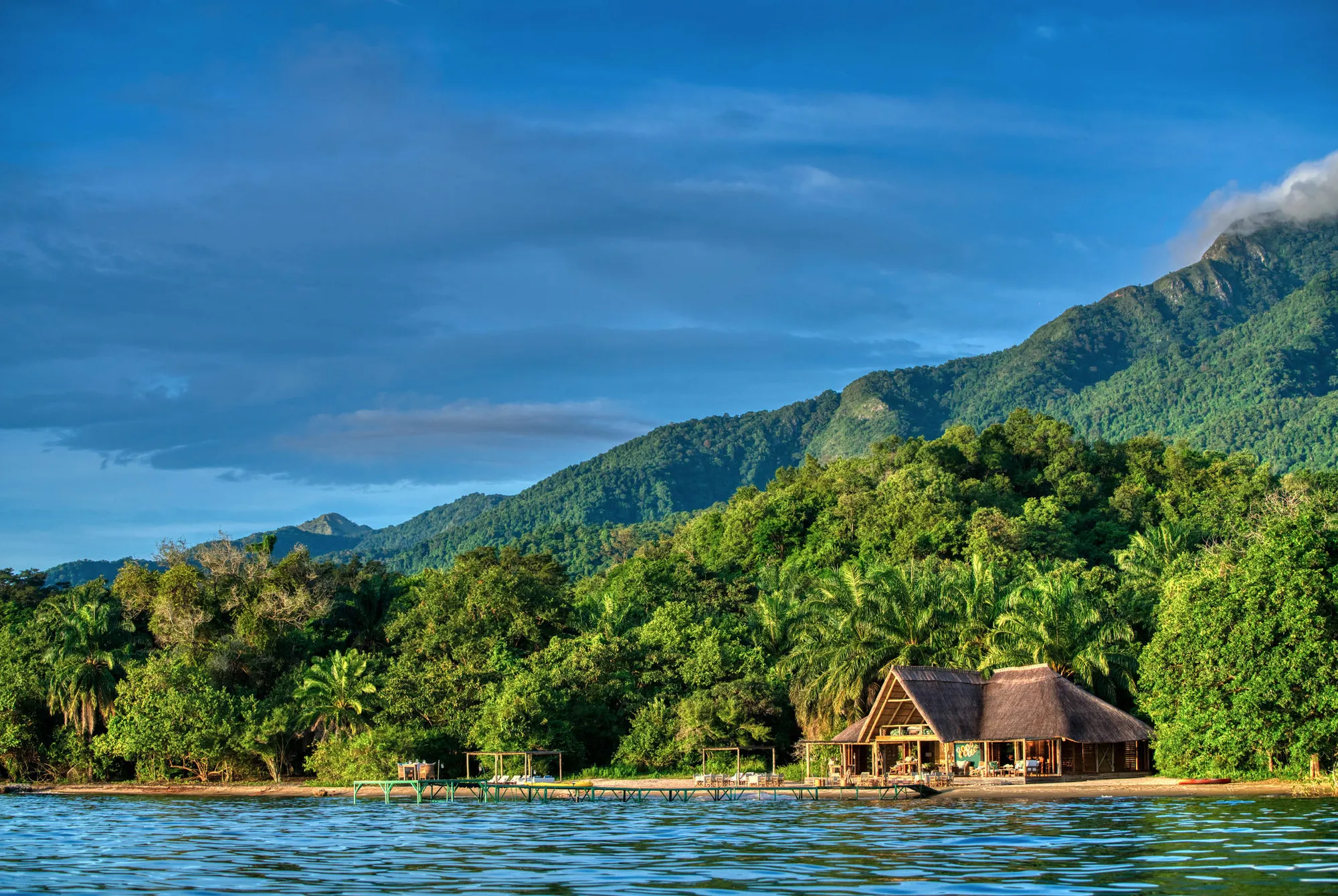 Mahale Mountains National Park Tanzania with lush forested mountains rising above the shores of Lake Tanganyika